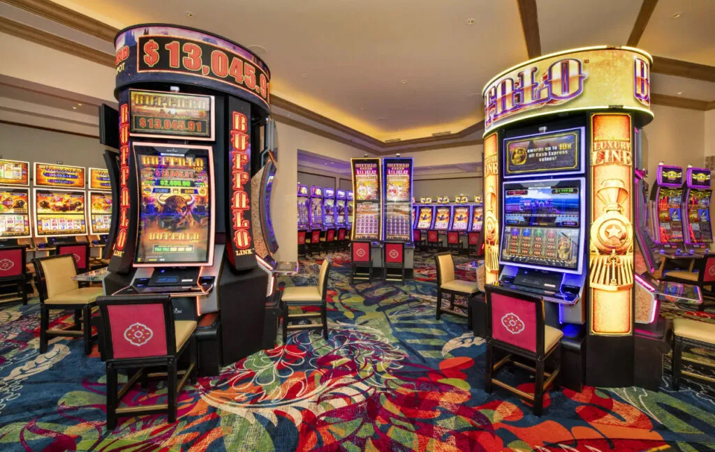 Inside Beau Rivage Resort &amp; Casino in Biloxi, with rows of slot machines lit up across the casino floor