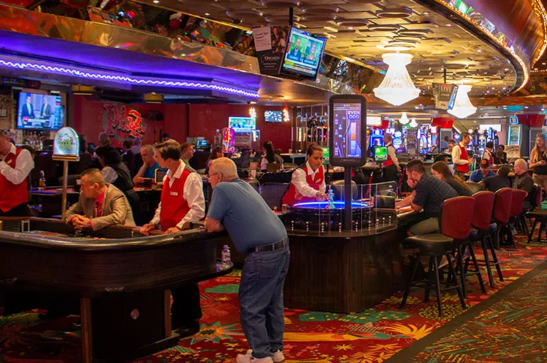 Busy Las Vegas casino floor with slot machines and players, a popular option for Utah residents seeking legal gambling