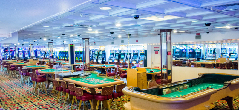 Casino floor on South Carolina's Big M Casino cruise ship with slot machines and table games in view