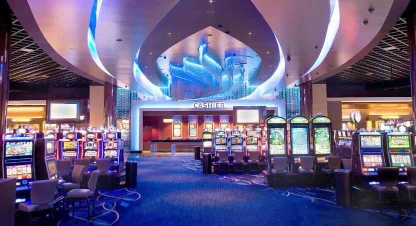 Gaming area at Wind Creek Wetumpka featuring rows of machines and bright lights