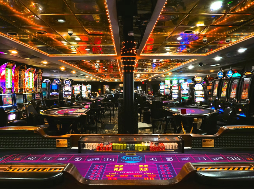 Casino floor aboard the Emerald Princess cruise ship with slot machines and table games